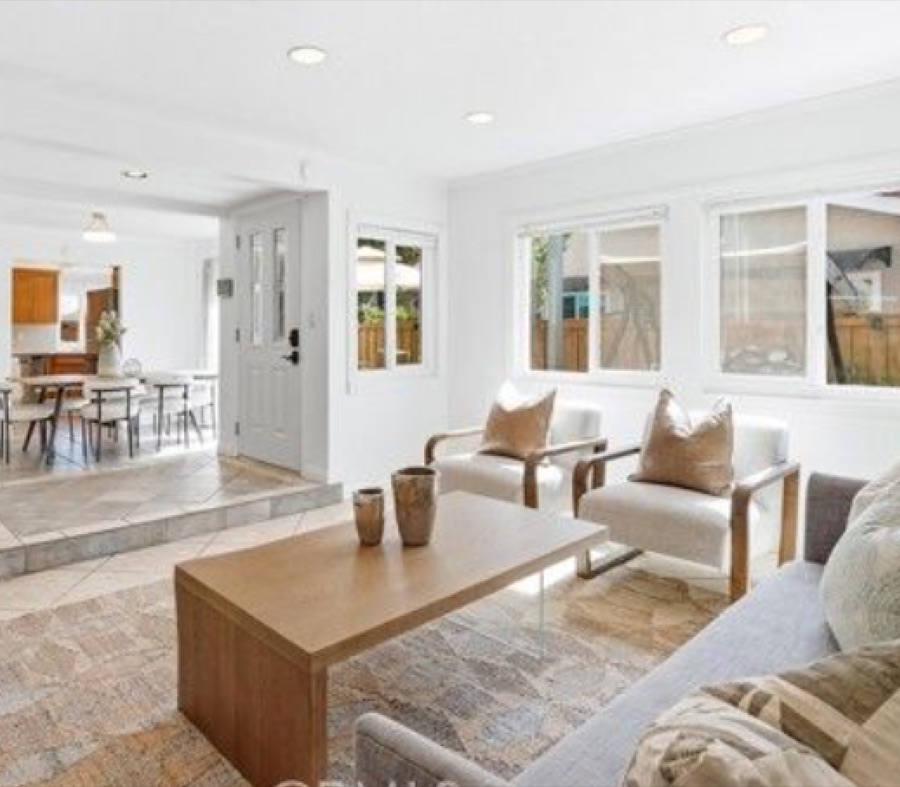 Bright living room at 8322 Padrino opening to the dining area, with recessed lighting and staged seating