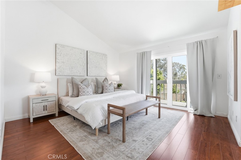 Primary bedroom at 8322 Padrino with vaulted ceiling and balcony access